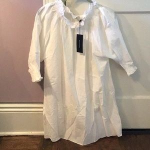 White long smocked top. Ruffle neck.